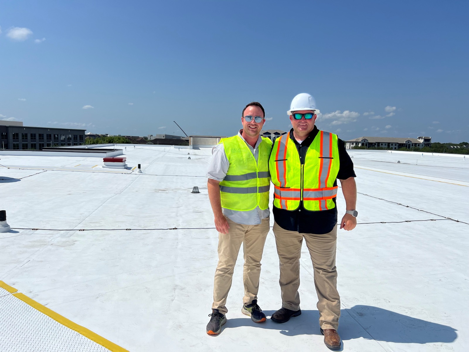 USI Roofing team members on a commercial roof